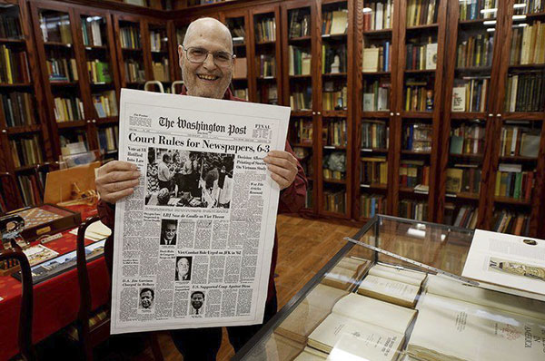 Frank Romano displays an historic front page from The Washington Post